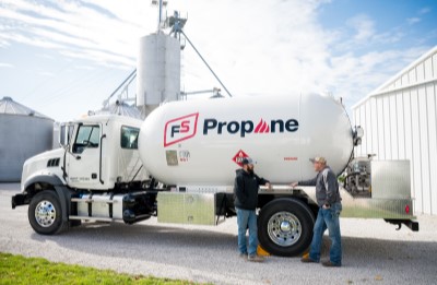 fs propane specialist speaking to farmer in front of delivery truck on farm